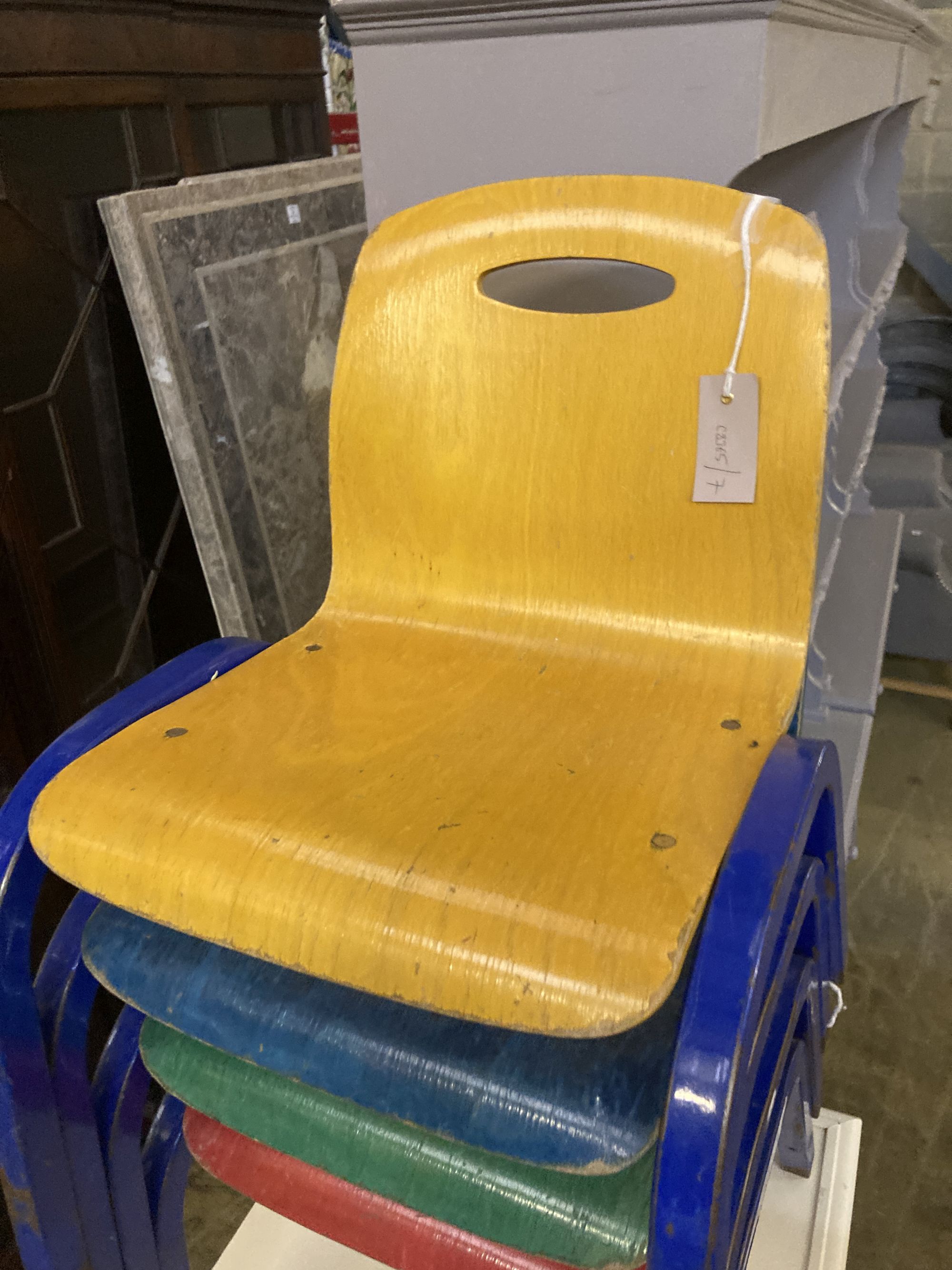 A set of four metal and ply childs stacking chairs